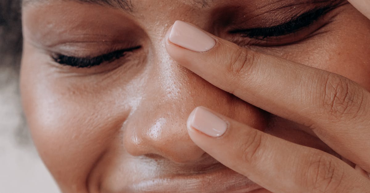 Warm close-up portrait of a black woman laughing joyfully, capturing genuine emotion.